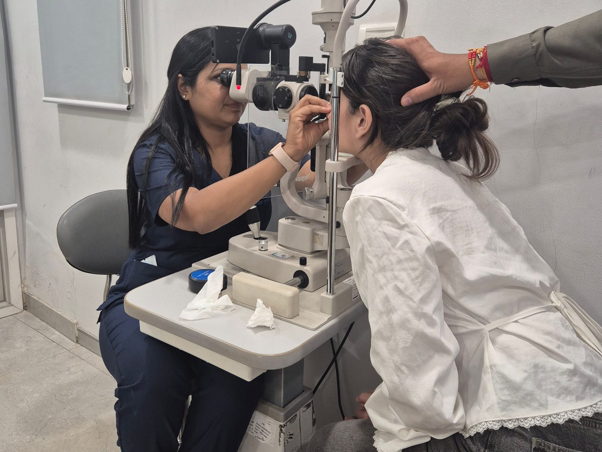 Doctor examining a patient at the slit lamp
