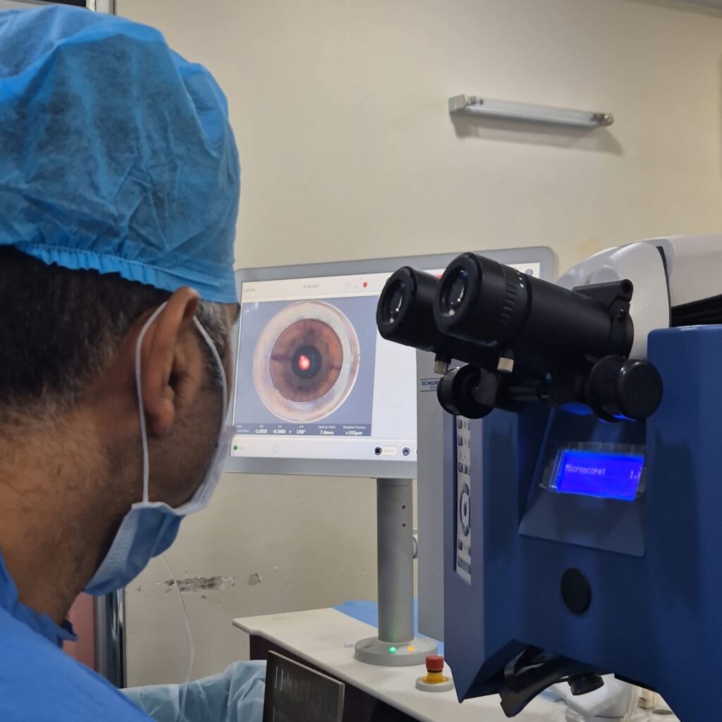 Surgeon at the Schwind laser with an eye scan on screen
