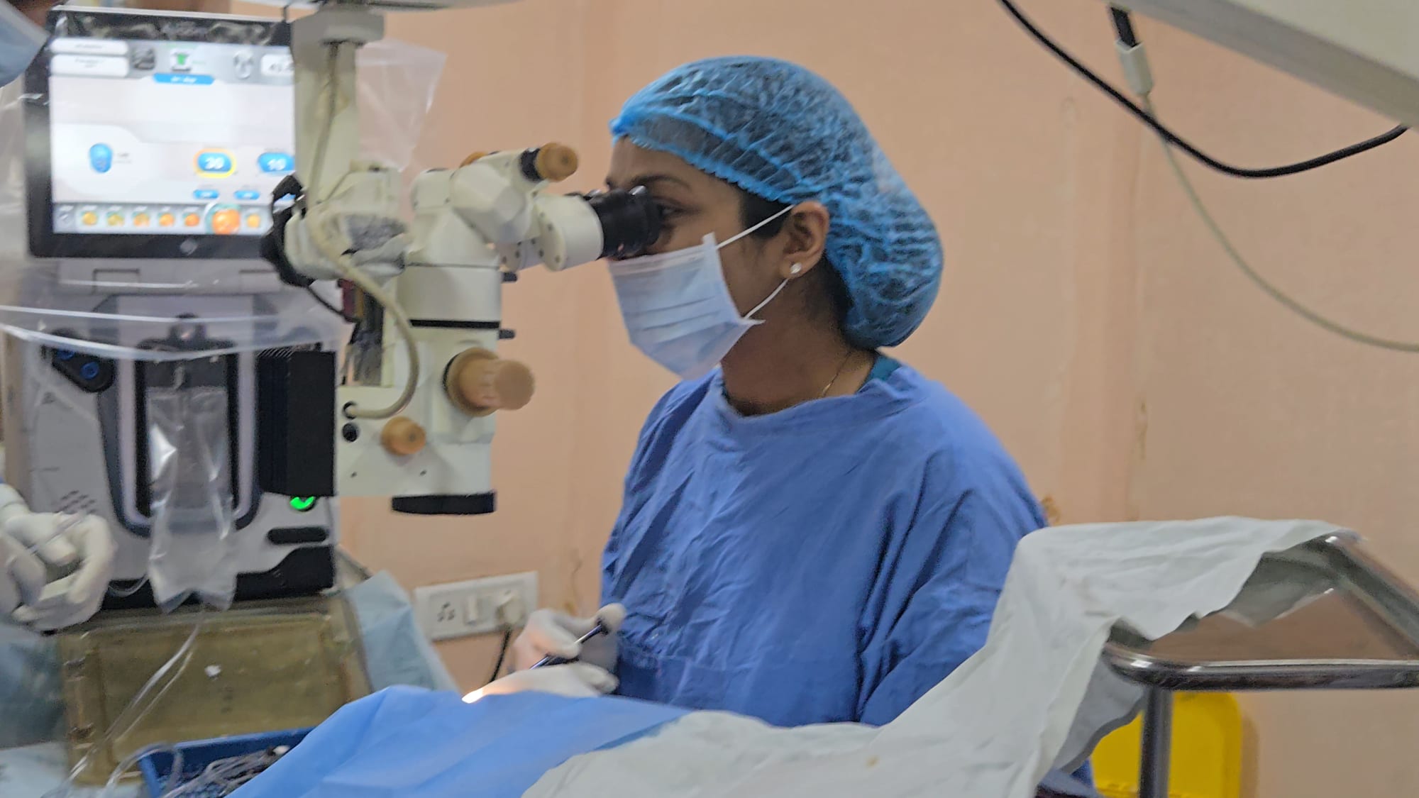 Eye surgeon at the operating microscope