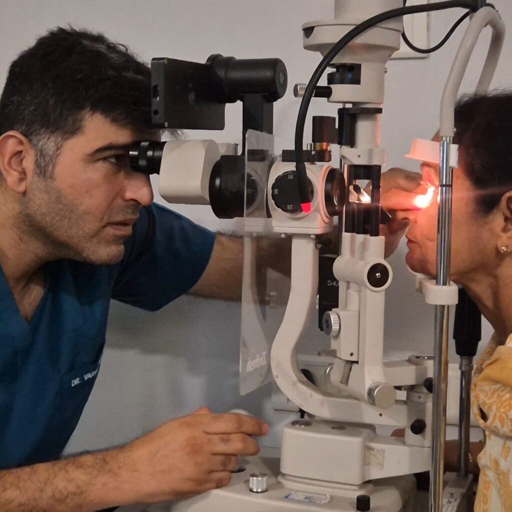 Eye specialist examining a patient at the slit lamp