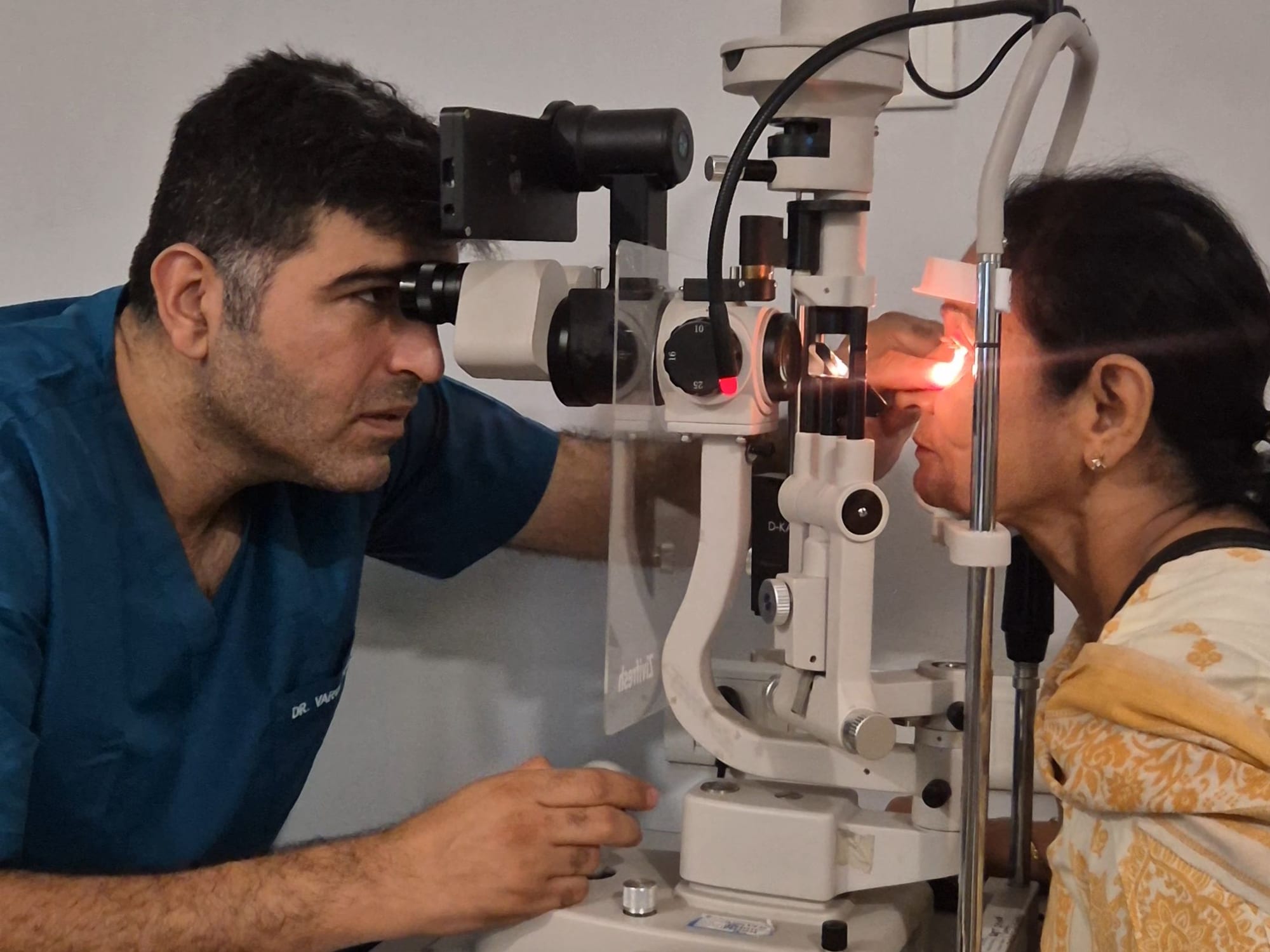 Eye specialist examining a patient at the slit lamp